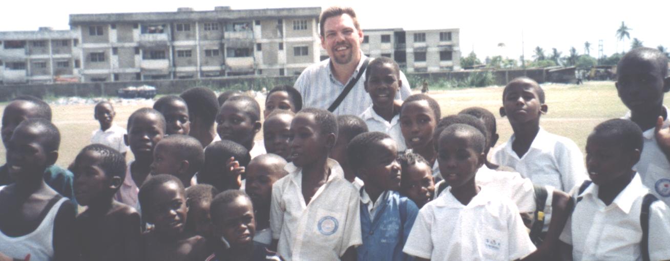 Missionary to Belize Chuck Kleffman with some African school children.