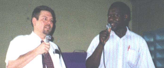 Missionary to Belize Chuck Kleffman speaking at an African church with an interpreter.