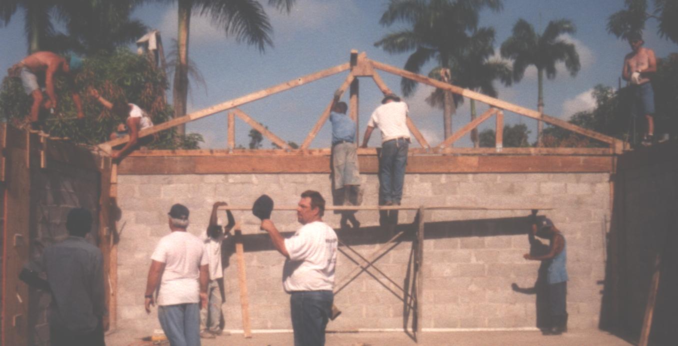 Church under construction in the cane fields. Missionary to Belize Chuck Kleffman is in center of picture.